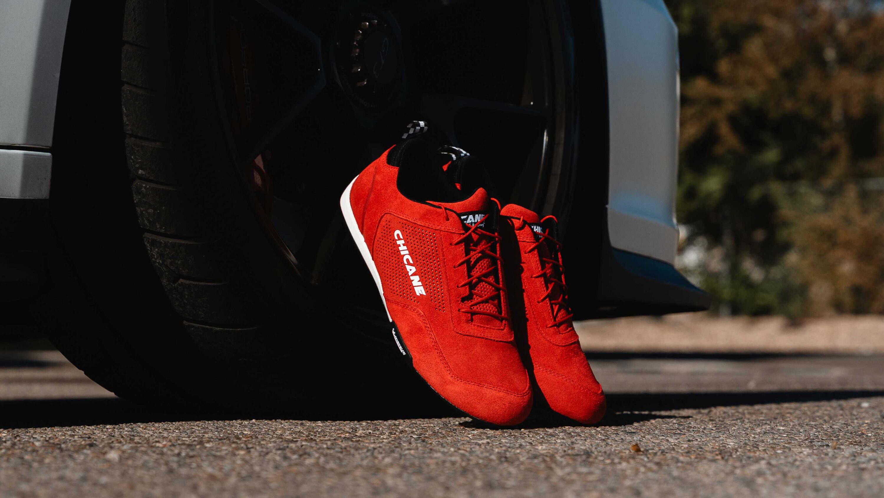 Speedster low-cut motorsport driving shoes in red, designed for track days and HPDE. Features flexible, lightweight construction and Michelin performance soles for precise pedal control and comfort. Ideal for sim racers and performance driving. Available in men’s and women’s sizes.