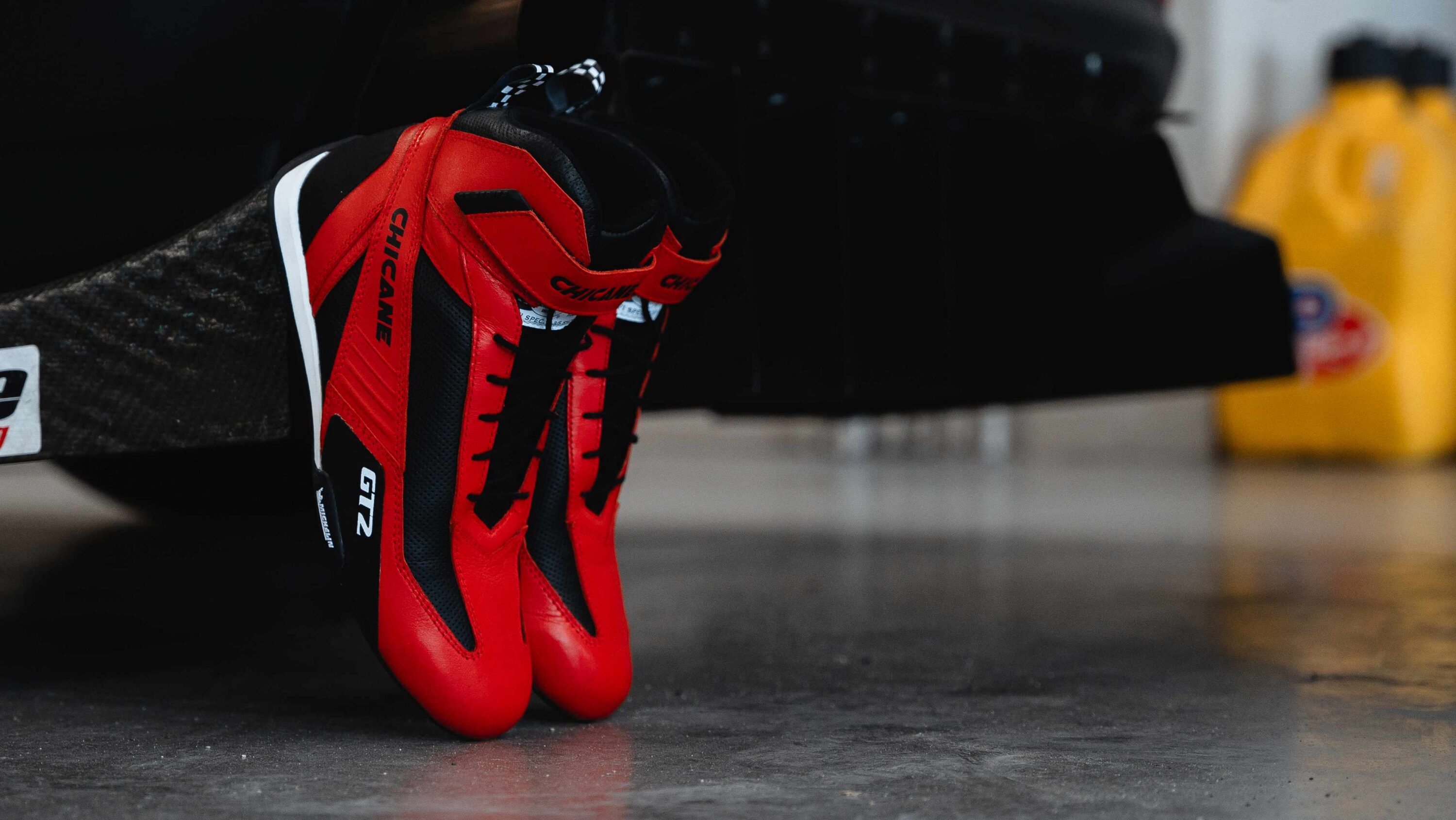 GT2 motorsport racing shoes in red and black with durable top-grain cowhide leather, Michelin performance tread, and SFI certification, designed for club racing and time trial drivers seeking reliable pedal feel, long-lasting durability, and balanced performance.