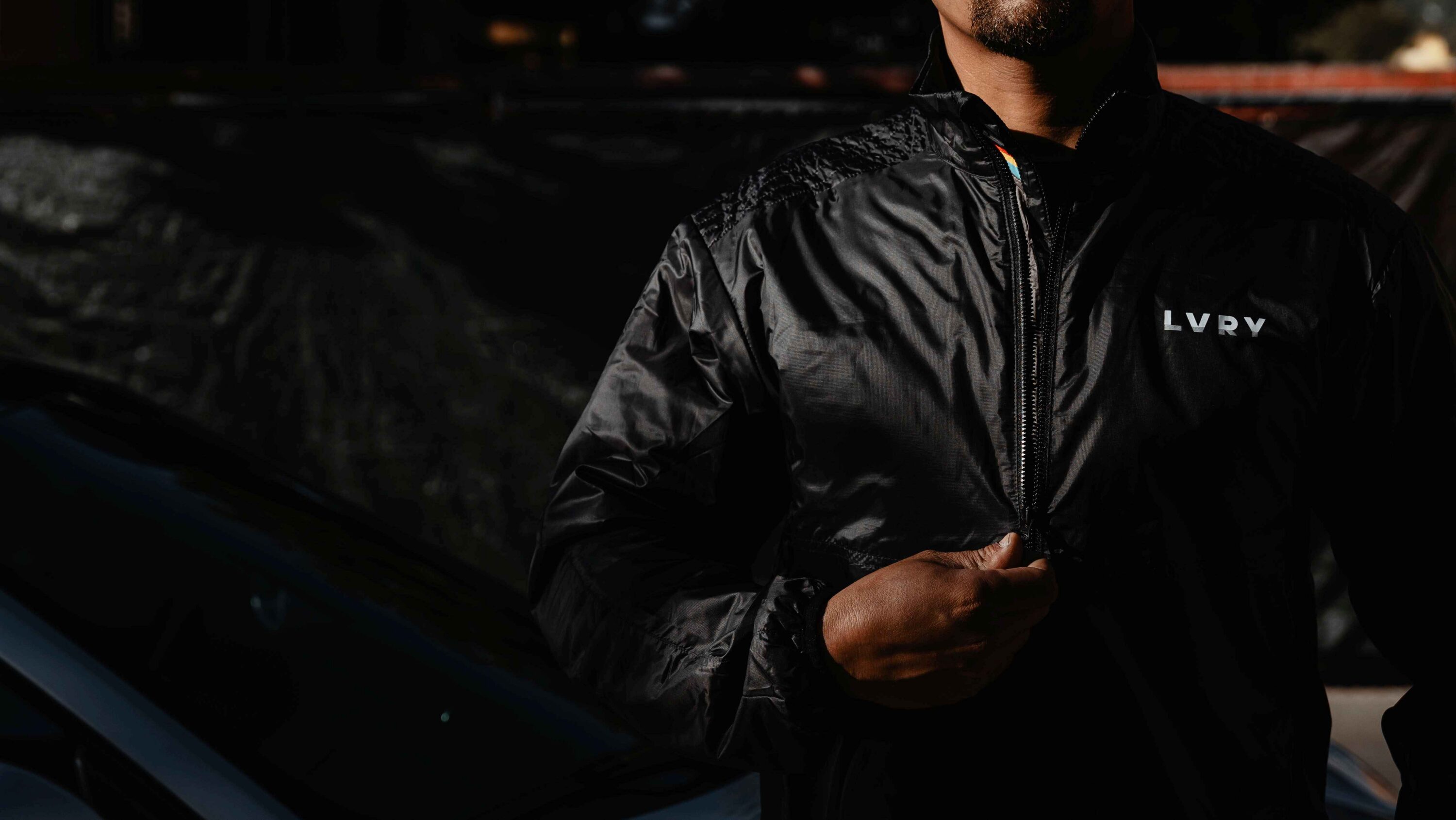 LVRY DRAFT Insulator black lightweight insulated jacket shown zipped, breathable motorsport-inspired outerwear for lightweight warmth and mobility.