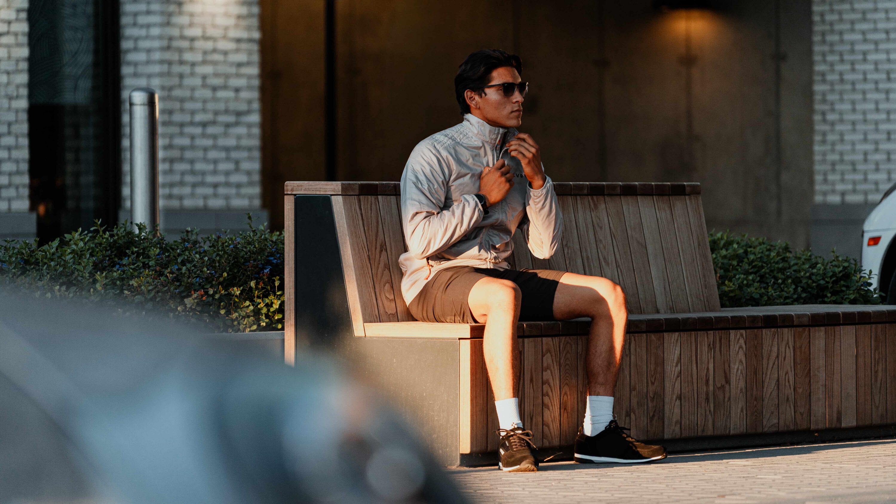 LVRY SPRINT Shorts styled with lightweight jacket in urban setting, versatile stretch performance shorts built for track, travel, and everyday movement.